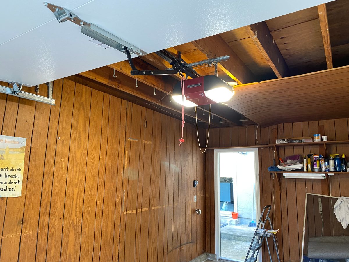 Old red LiftMaster garage door opener before replacement