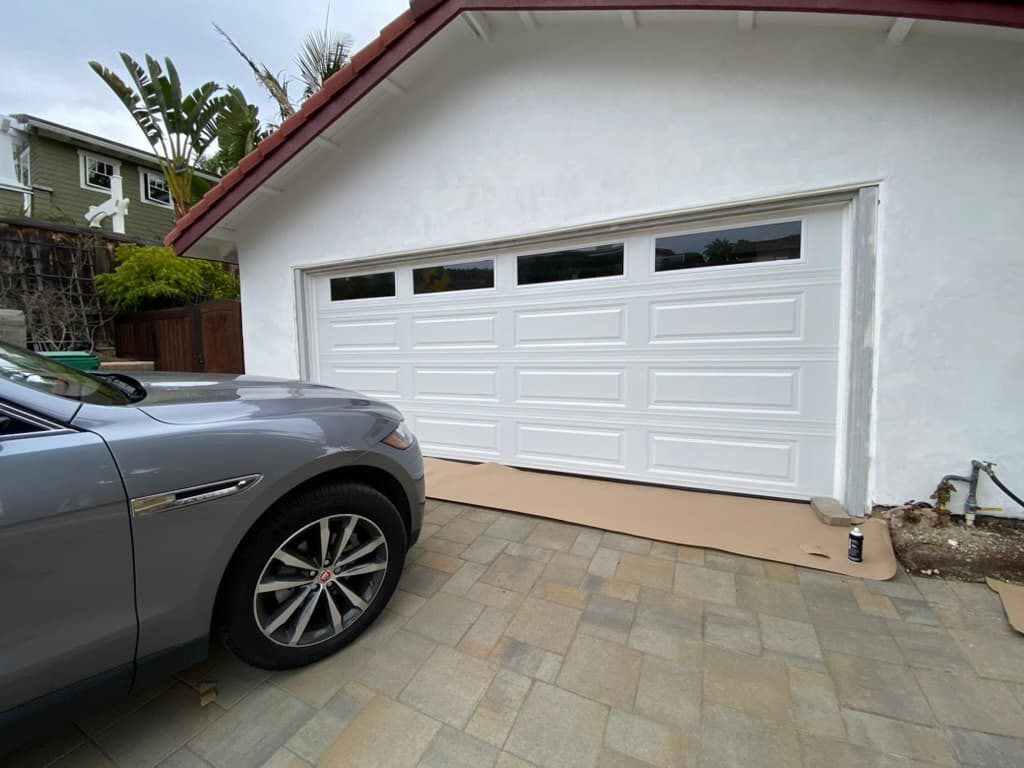 Three black flush garage doors on a modern townhome, Bay Park