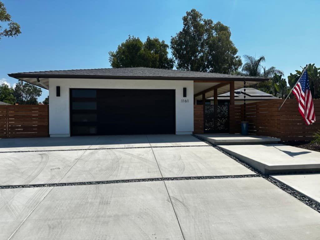 Black modern garage door with windows during install, Santee