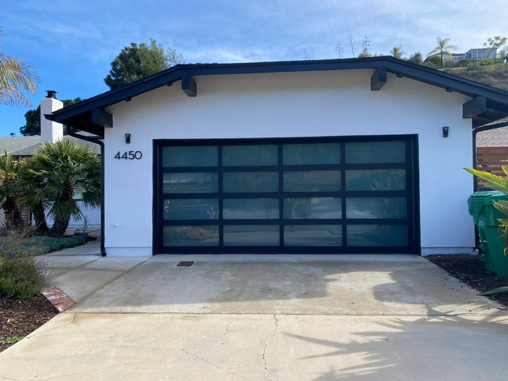 White full-view glass garage doors on a townhome, UTC