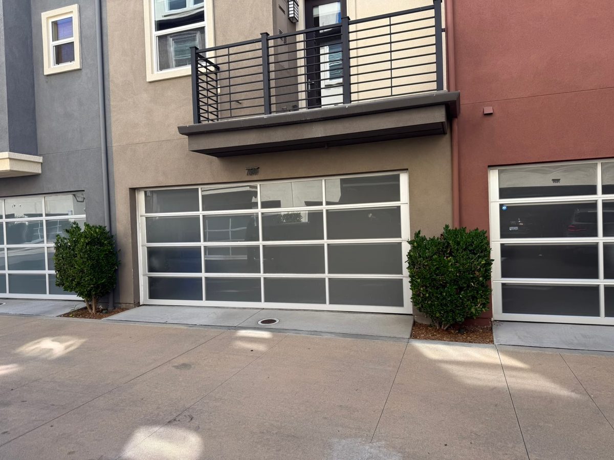 Tan wood-look carriage garage doors with windows, Mission Valley