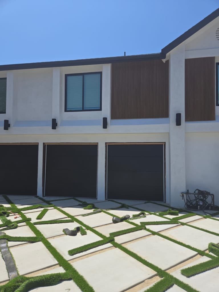 Black full-view glass garage door on a coastal home, San Diego