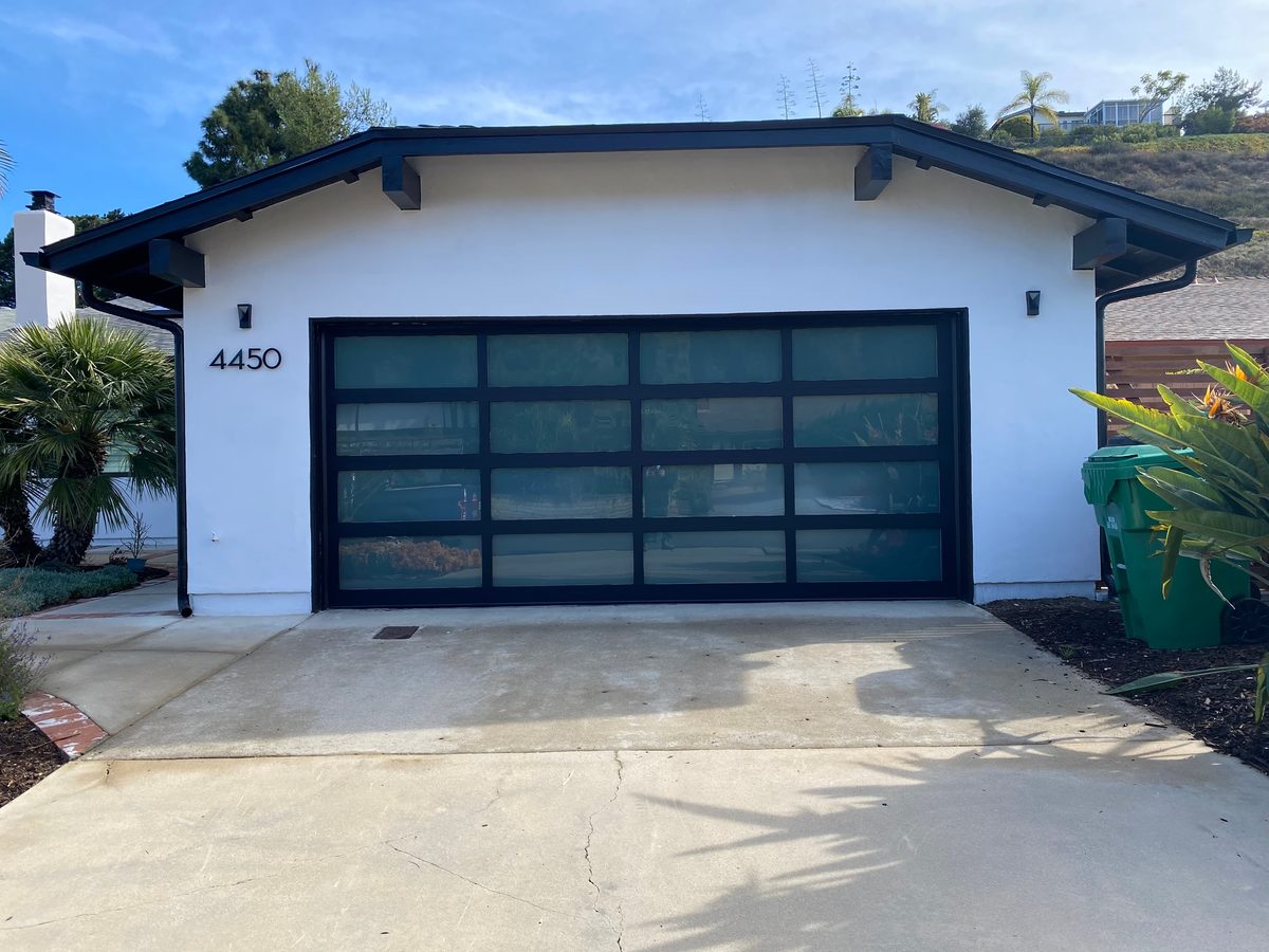 Black full-view glass two-car garage doors on a new build, San Diego