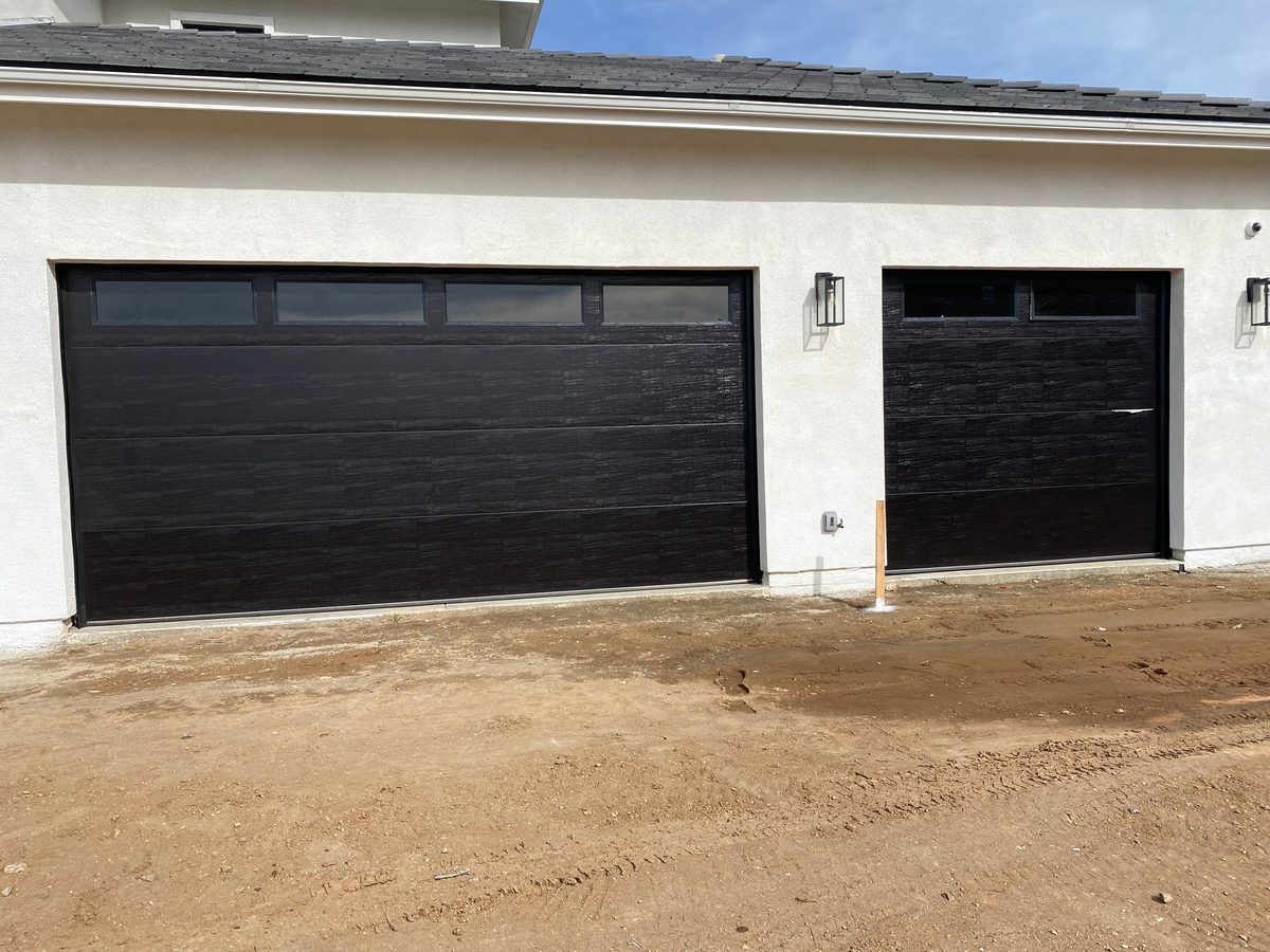 Brown carriage-style garage door with arched windows, El Cajon