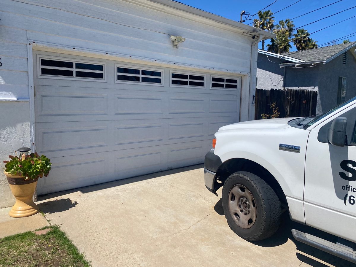 White-frame full-view glass garage door, Ocean Beach