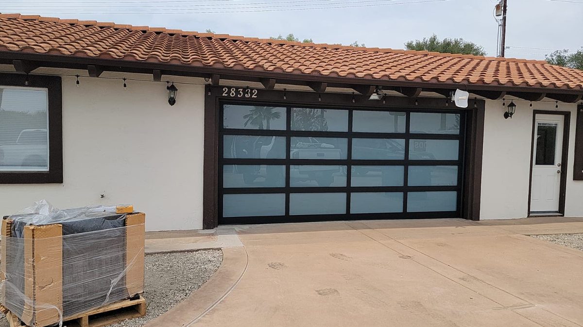 Black wood-look modern garage doors on a new build, Hillcrest